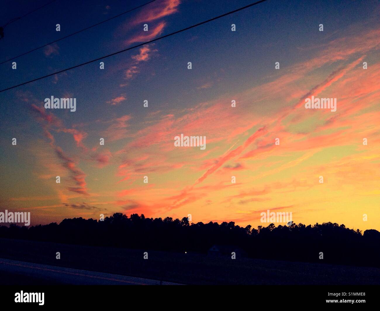 Pink cloud ribbons in blue sky in North Carolina - Smartphone Captured Stock Image