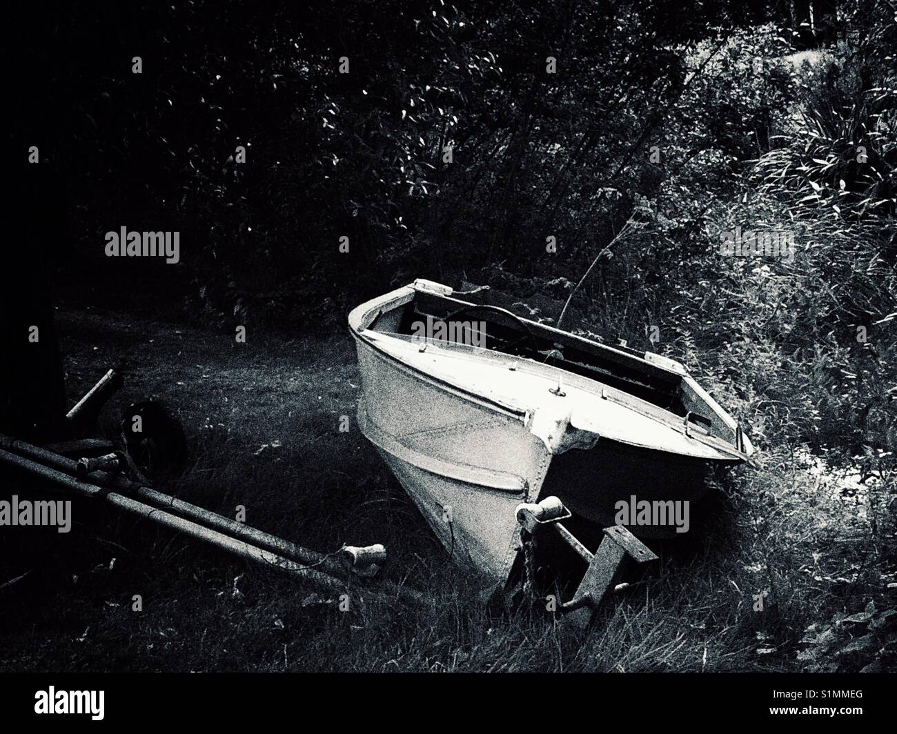 Rowing boat on a riverbank in black and white Stock Photo