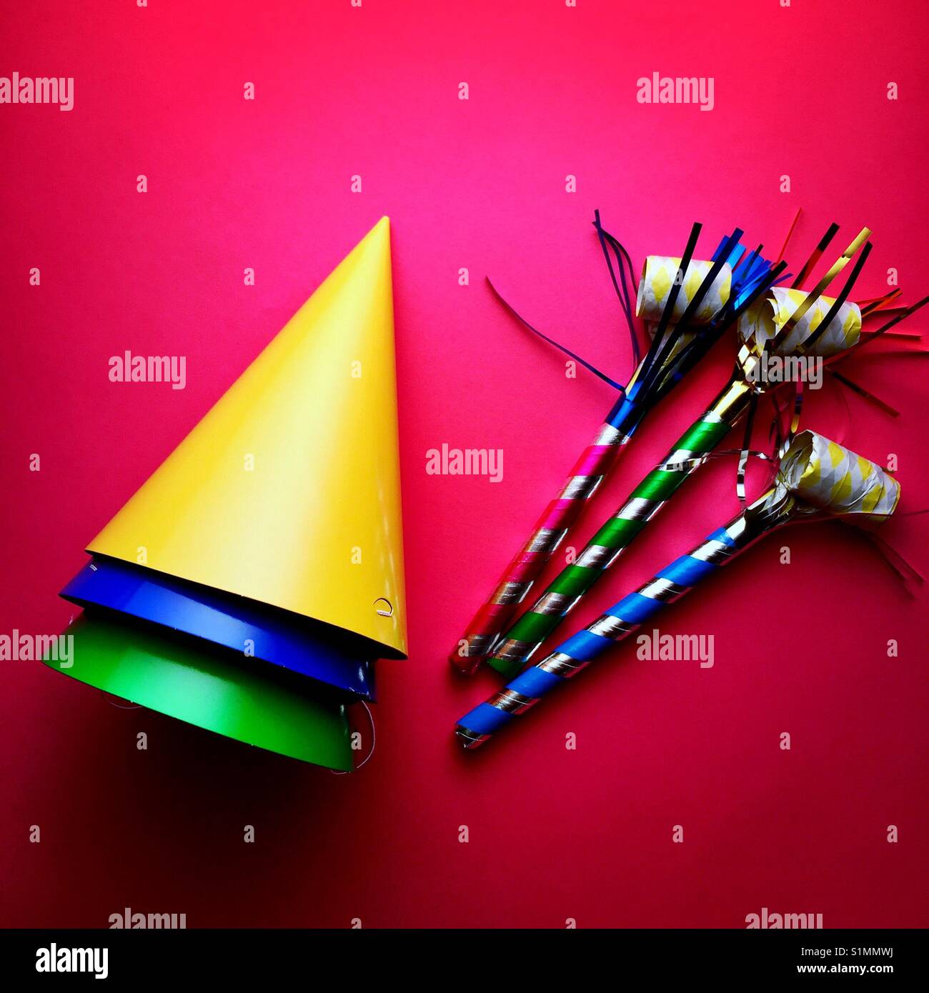 A bright colourful shot of party hats and noise makers Stock Photo
