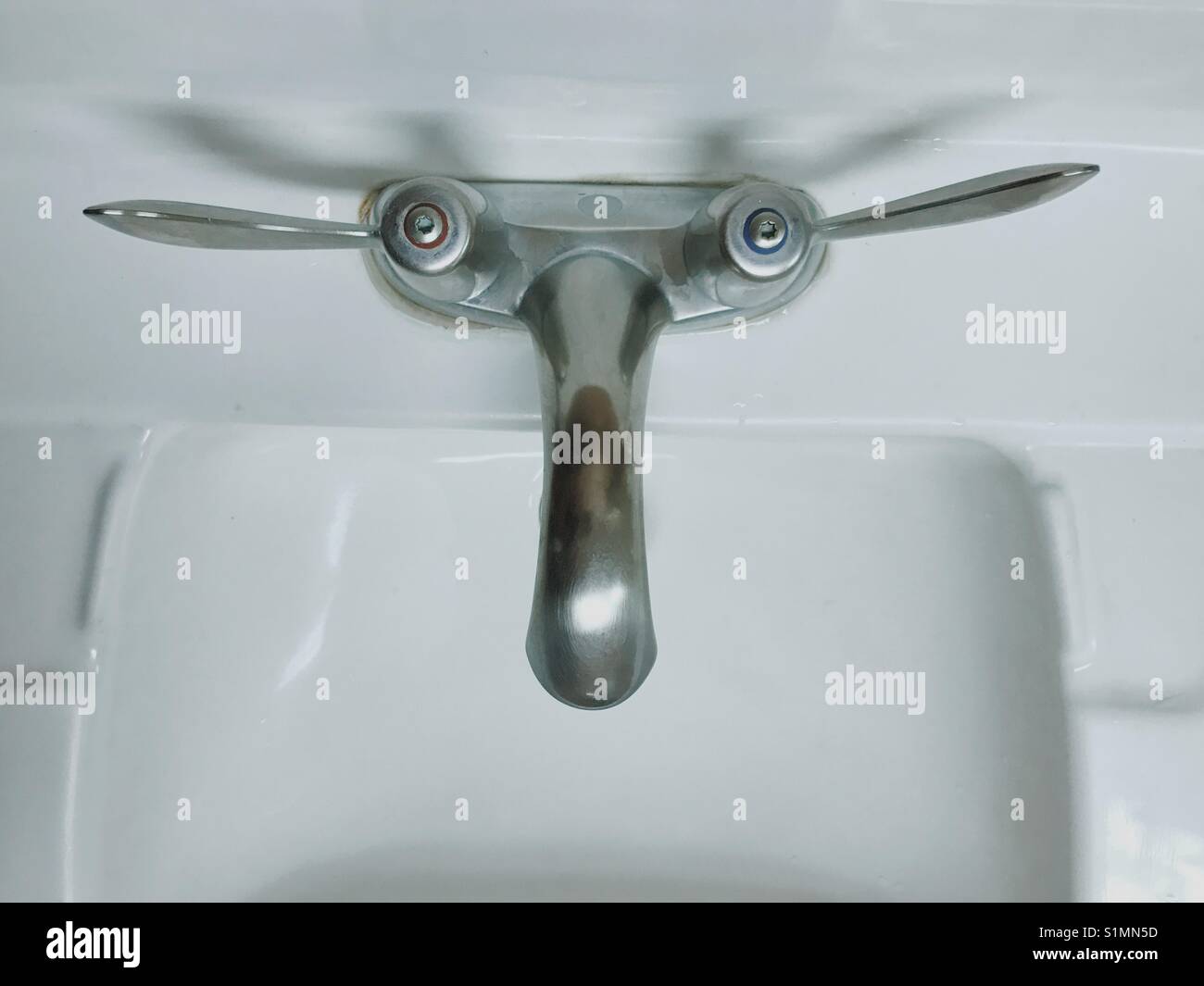 A found face, seen at a public restroom sink in New Jersey, USA. Stock Photo