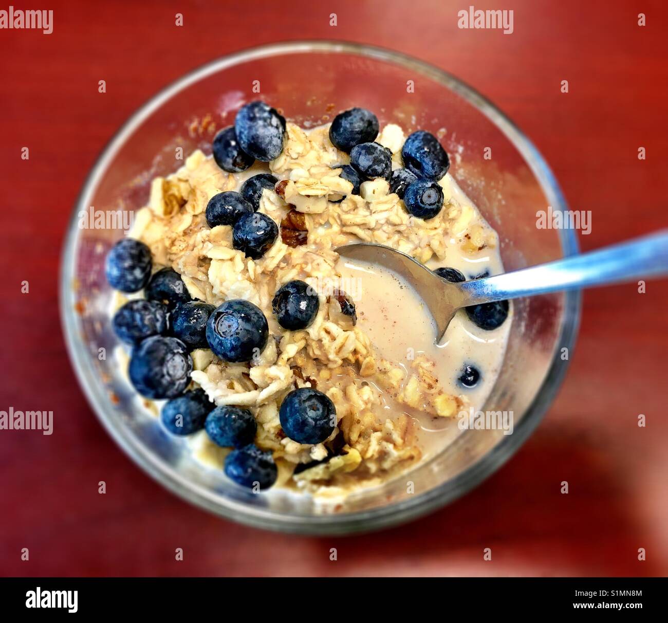 overnight oats with berries for breakfast Stock Photo Alamy