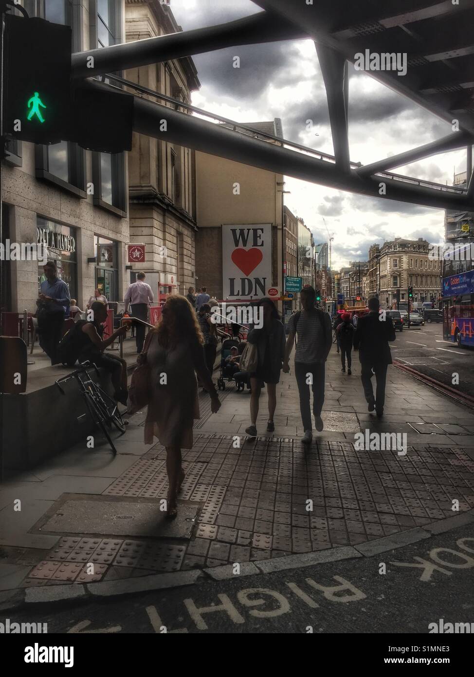 People walk down Borough High Street in London - Smartphone Captured Stock Image