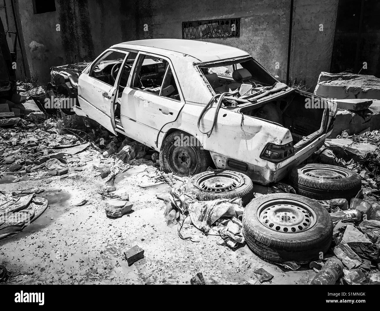 A vehicle damaged in Aida Camp in Bethlehem, Palestine, due to Israeli artillery fire during the second intifada of 2002. Stock Photo