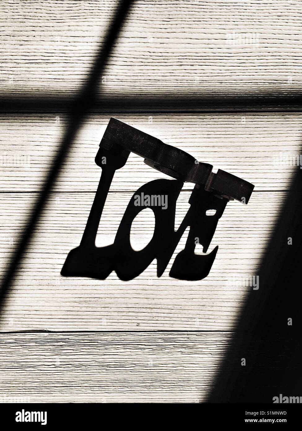 Love sign made with sun light and shadow - Smartphone Captured Stock Image