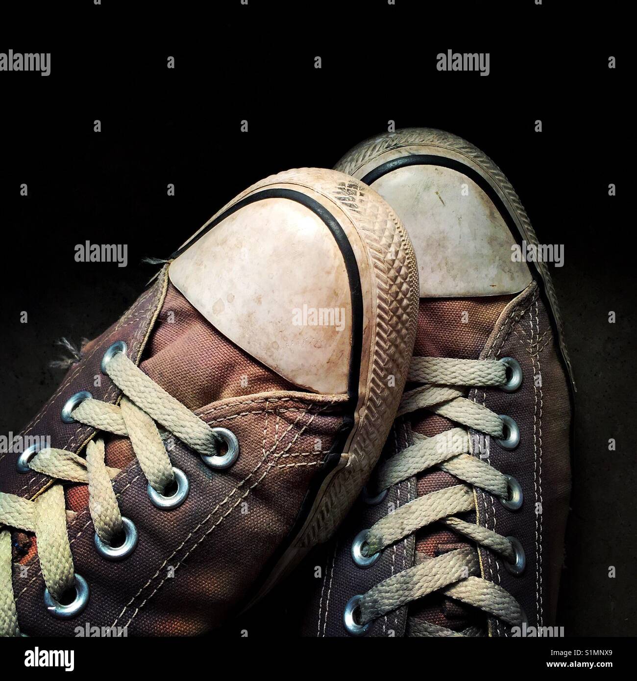 A moody close up detail shot of a pair of old worn out Converse sneakers  Stock Photo - Alamy