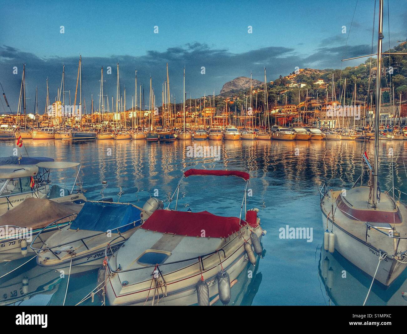 View from the sea wall over the yacht club towards the port and Montgo mountain. Javea, Alicante, Spain Stock Photo