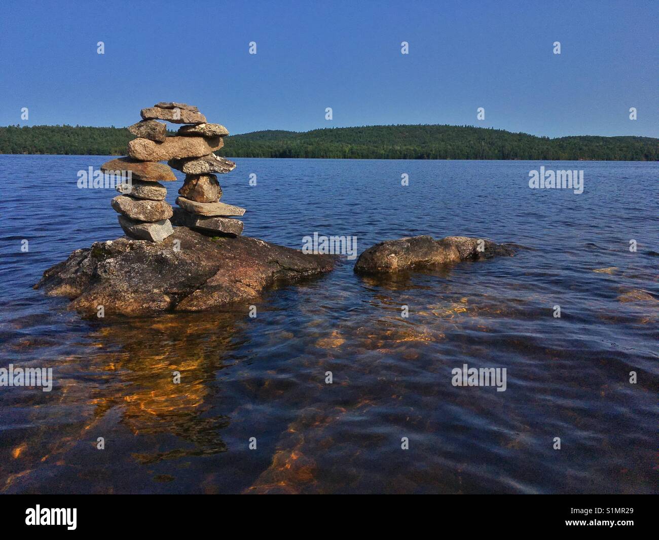 Inuksuk built on the top of the rock in Black Donald Lake in Ontario