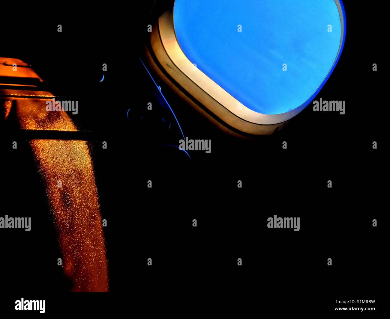 Sunlight reflection through airplane window - Smartphone Captured Stock Image