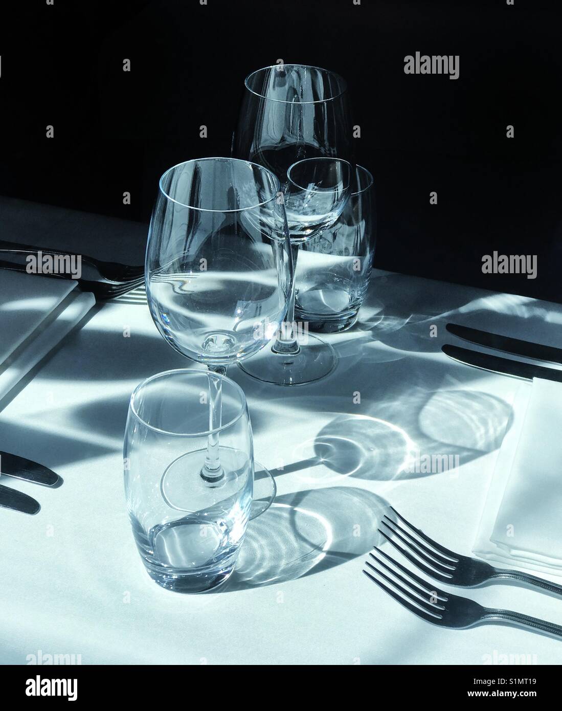 A place setting including glasses on a restaurant table - Smartphone Captured Stock Image