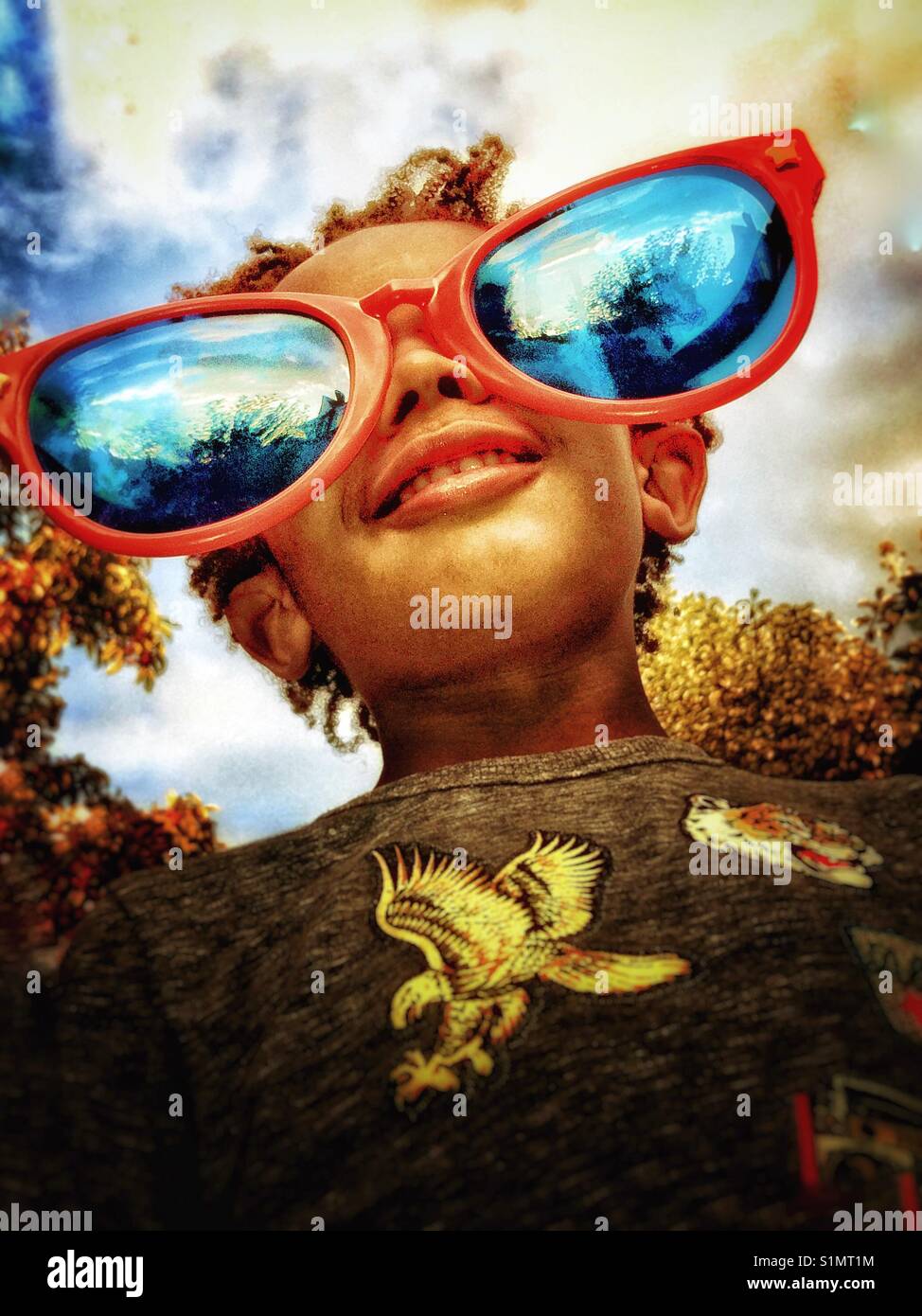 A little boy wearing huge sunglasses. Stock Photo