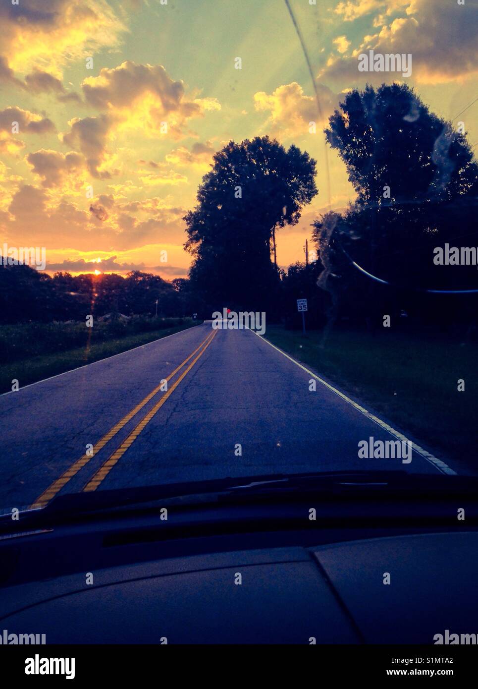 Through the windshield, into the sunrise-North Carolina - Smartphone Captured Stock Image