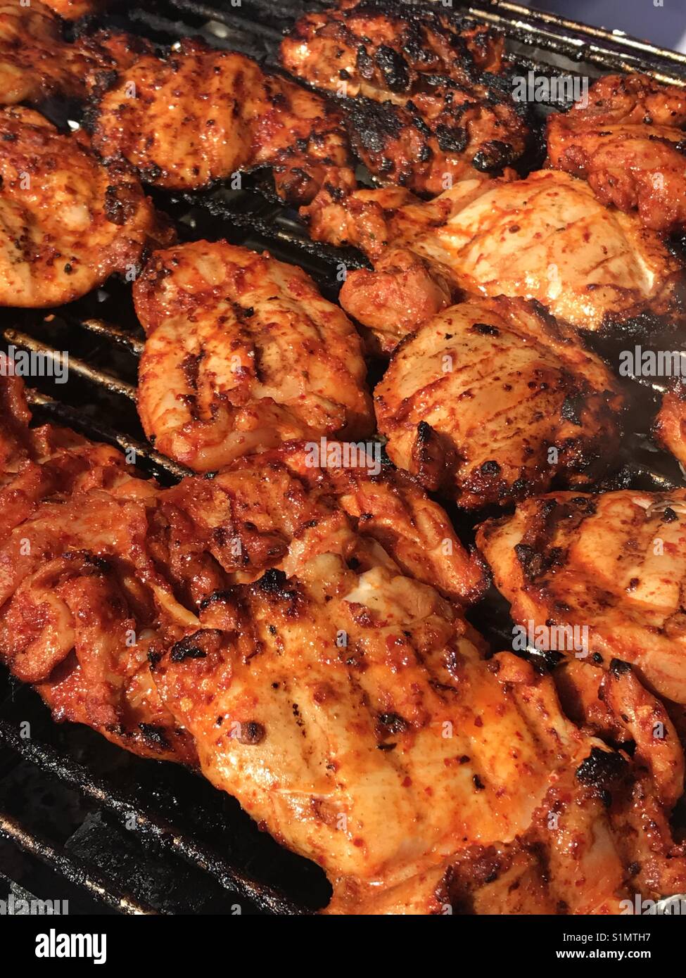 Barbecue spicy chicken on the grill Stock Photo