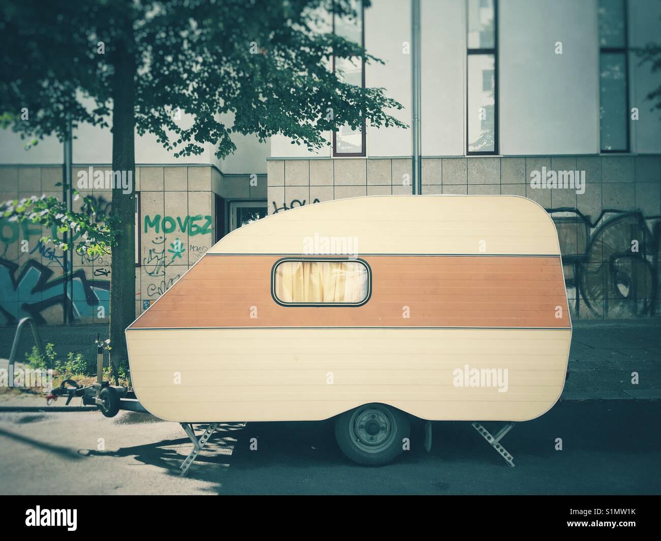 A caravan parked on a city street Stock Photo