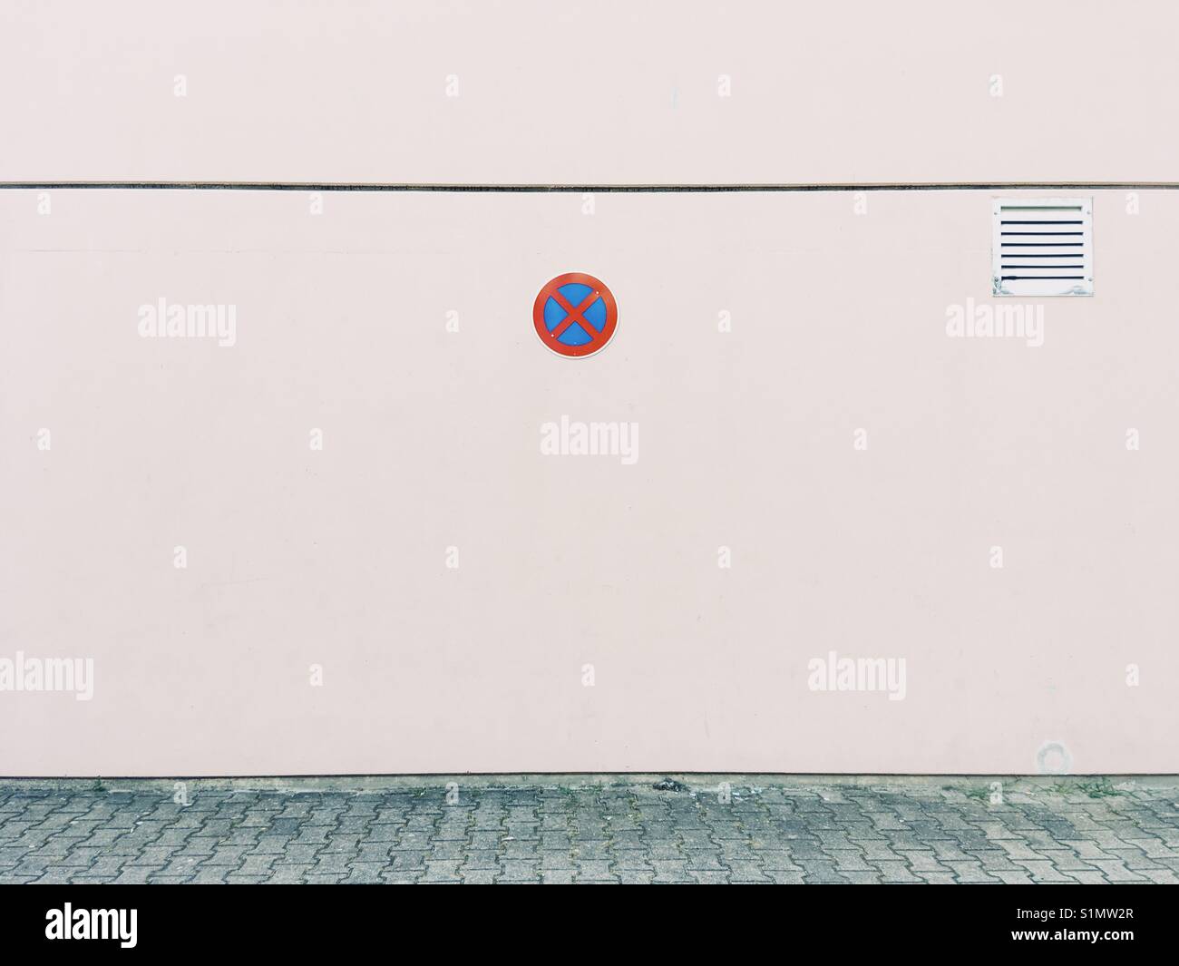 A parking prohibition sign on a white wall - Smartphone Captured Stock Image