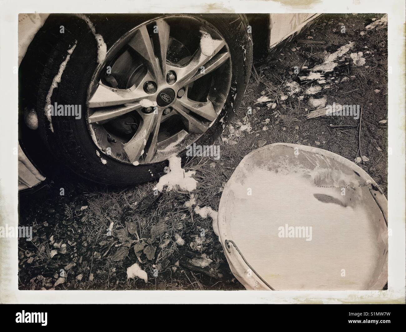 Car wash, bucket of soapy water and wheel Stock Photo