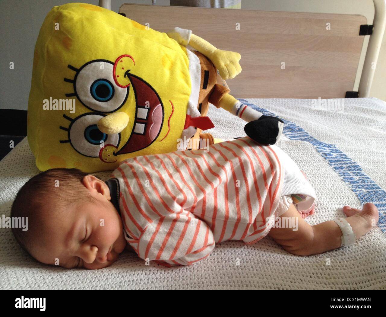 Sleeping new born baby with Sponge Bob Square Pants Stock Photo - Alamy