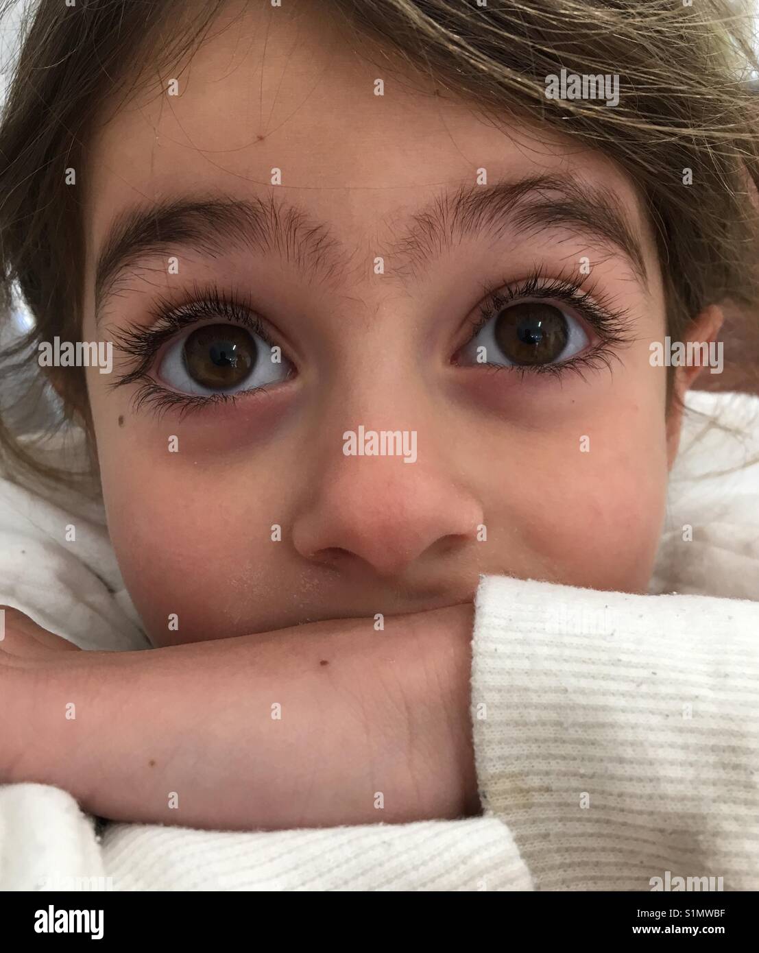 Little girl with big brown eyes Stock Photo