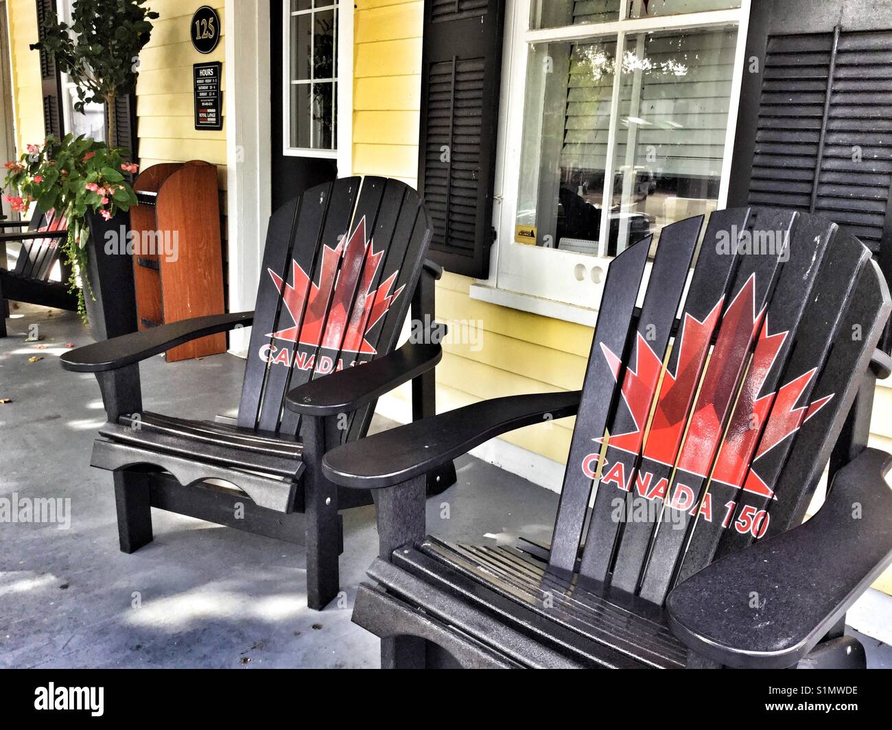 A cozy porch with two Muskoka chairs. - Smartphone Captured Stock Image