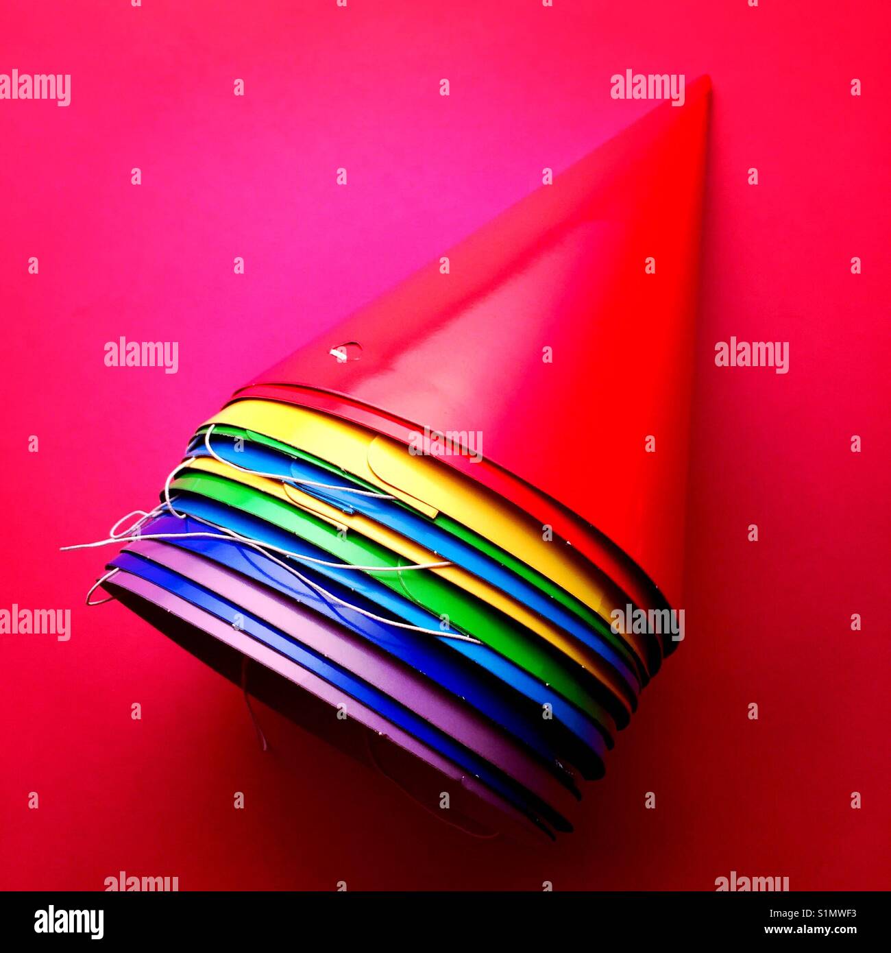 A bright colourful detail shot of a stack of party hats Stock Photo