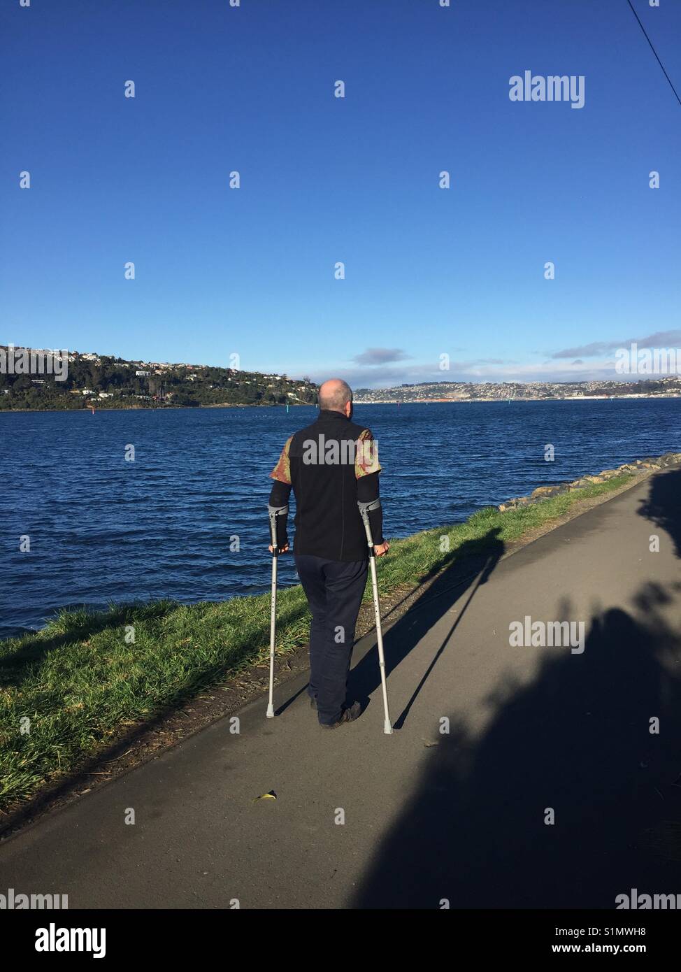 Walking with crutches after hip replacement Stock Photo Alamy