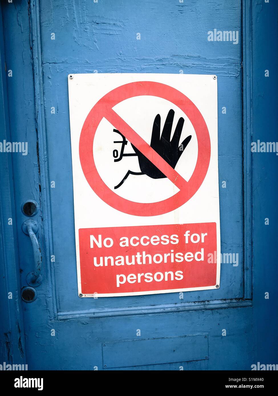 No access for unauthorised persons sign on blue door Stock Photo