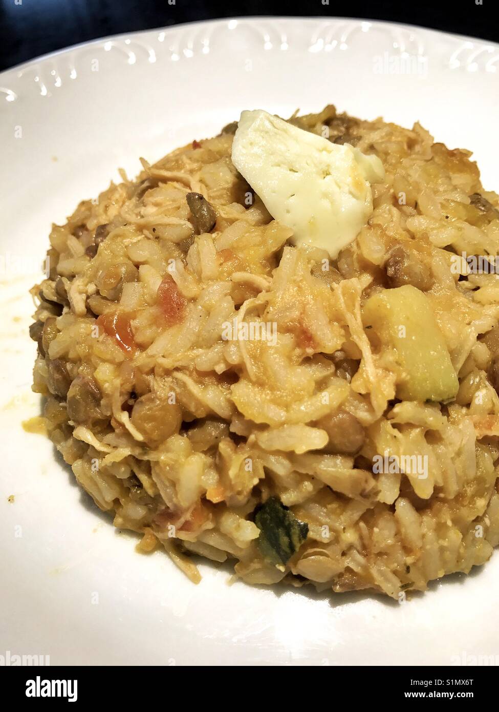 Rice with vegetables, lentil, chicken and cheese Stock Photo