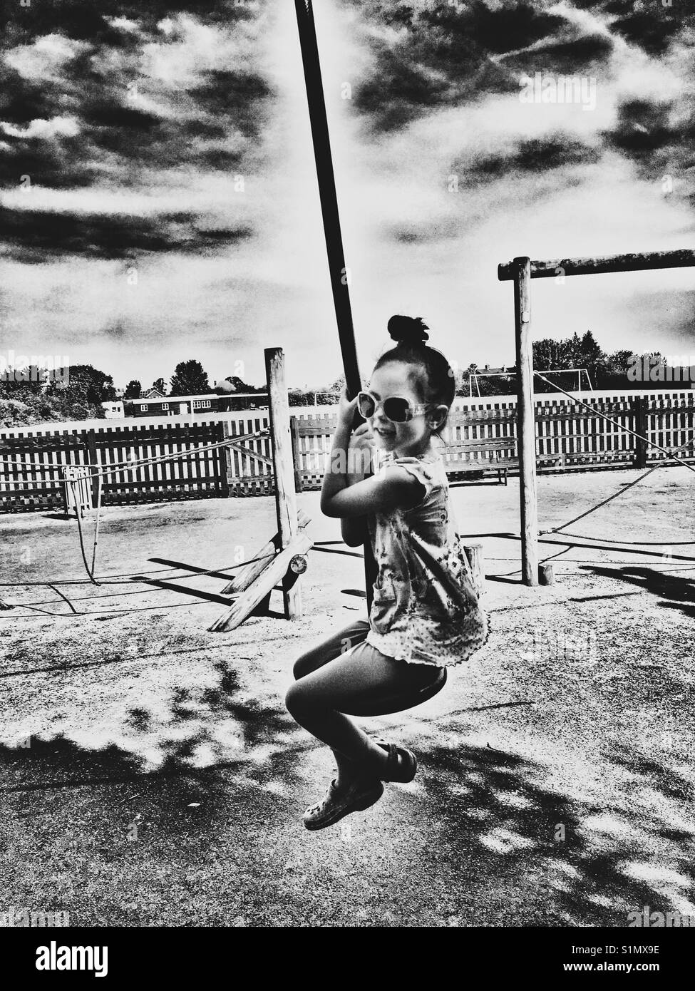Girl on playground zip wire, Bawdsey, Suffolk, UK. - Smartphone Captured Stock Image