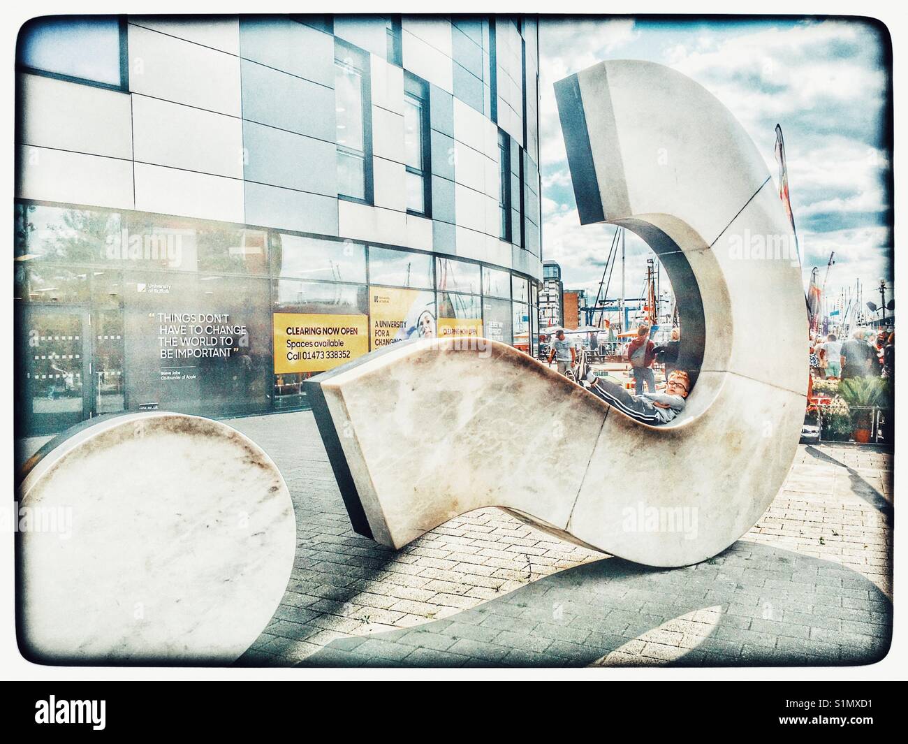 Boy chilling on huge Question Mark sculpture Stock Photo Alamy