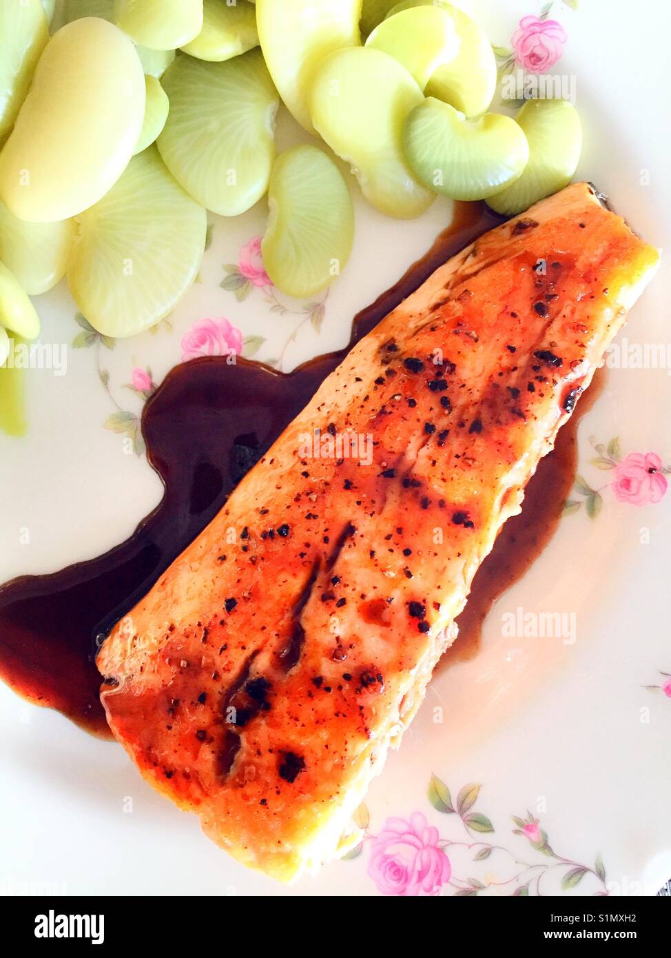 Gourmet meal of salmon with balsamic reduction and Dr. Martin heirloom lima beans, USA - Smartphone Captured Stock Image