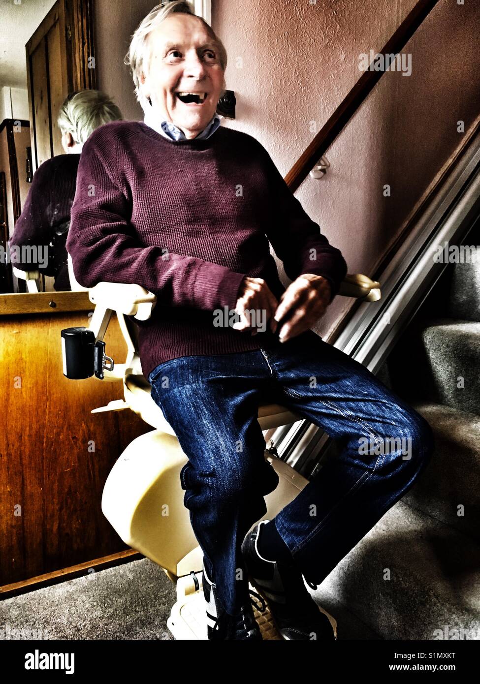 Laughing on the stair lift - Smartphone Captured Stock Image