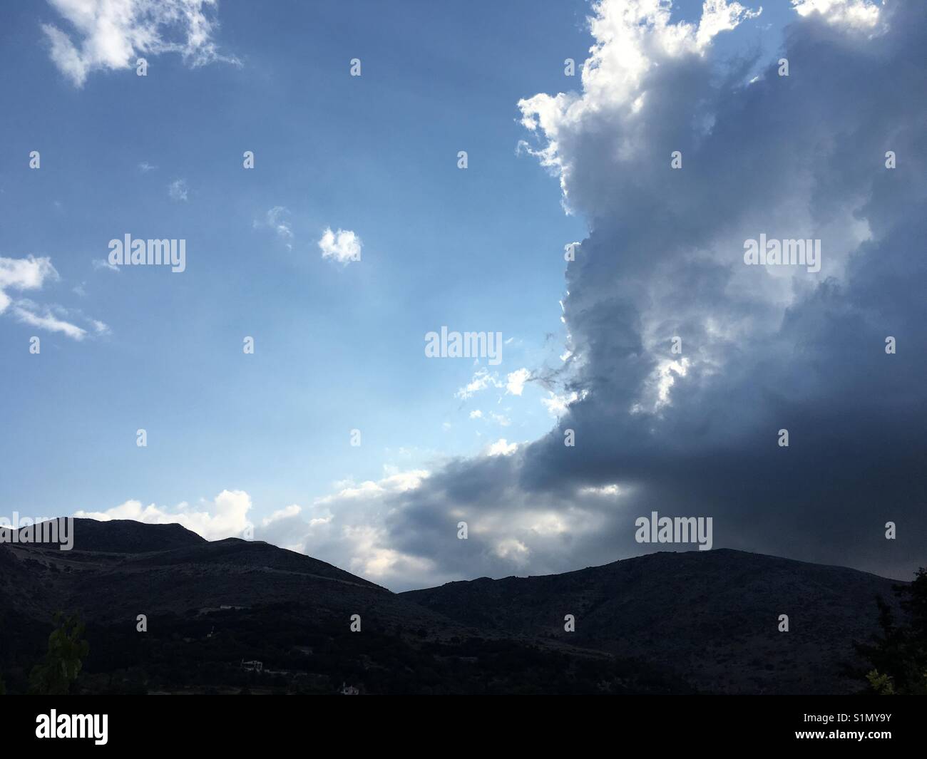 Rain coming over the mountain near Myrtis beach on Cefalonia island in Greece - Smartphone Captured Stock Image