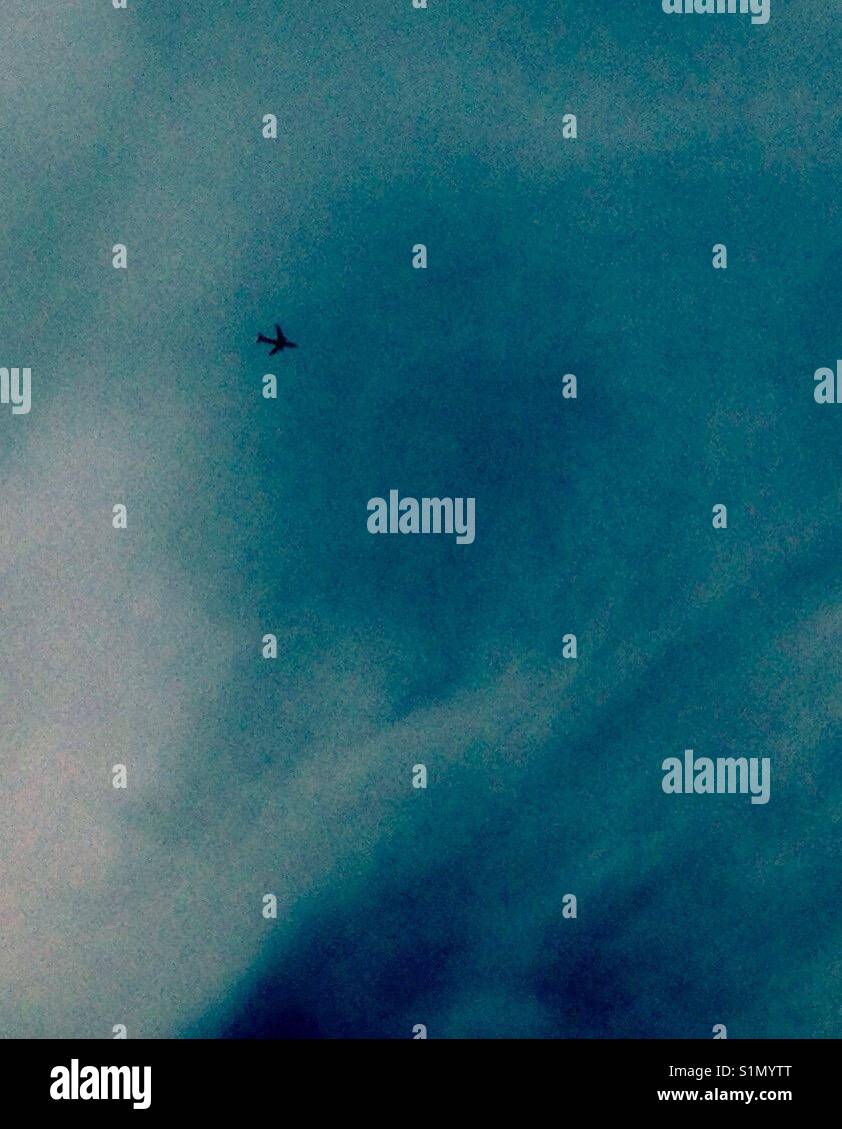 Airliner flies through curiously striated blue sky - Smartphone Captured Stock Image