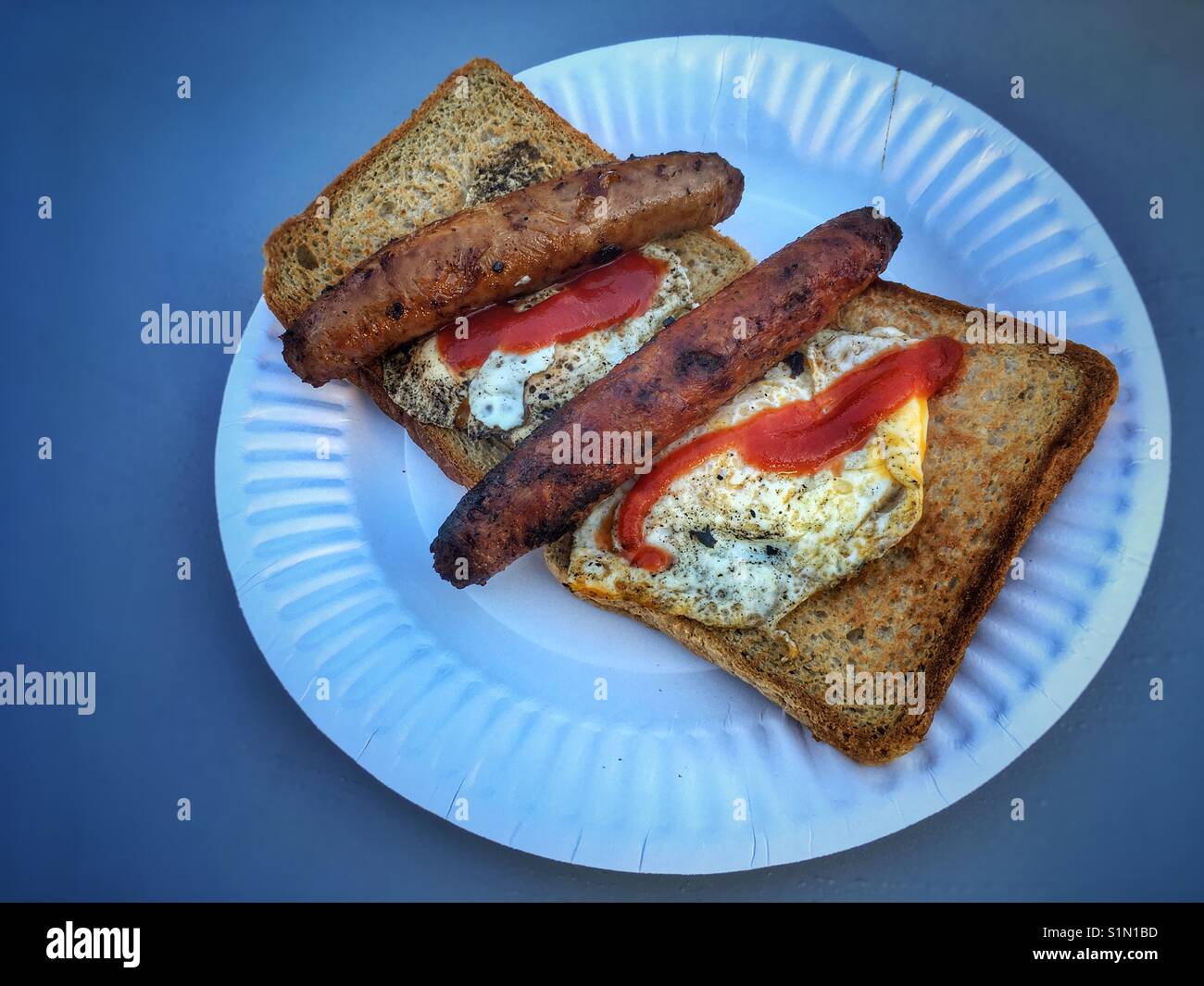 Sausages and eggs sandwiches on a paper plate. - Smartphone Captured Stock Image