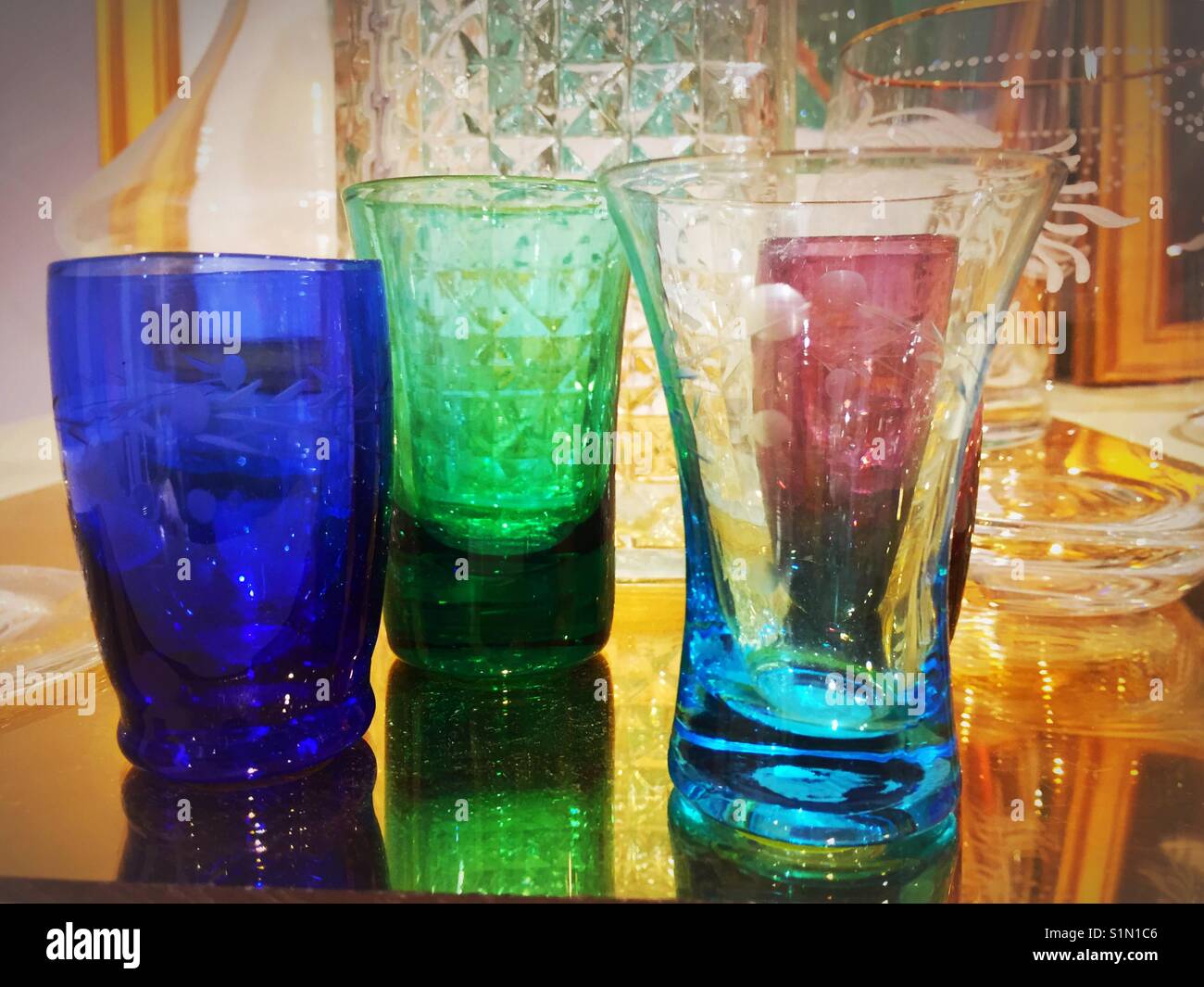 Colorful glass cordial and liqueur glasses display at retail store, NYC