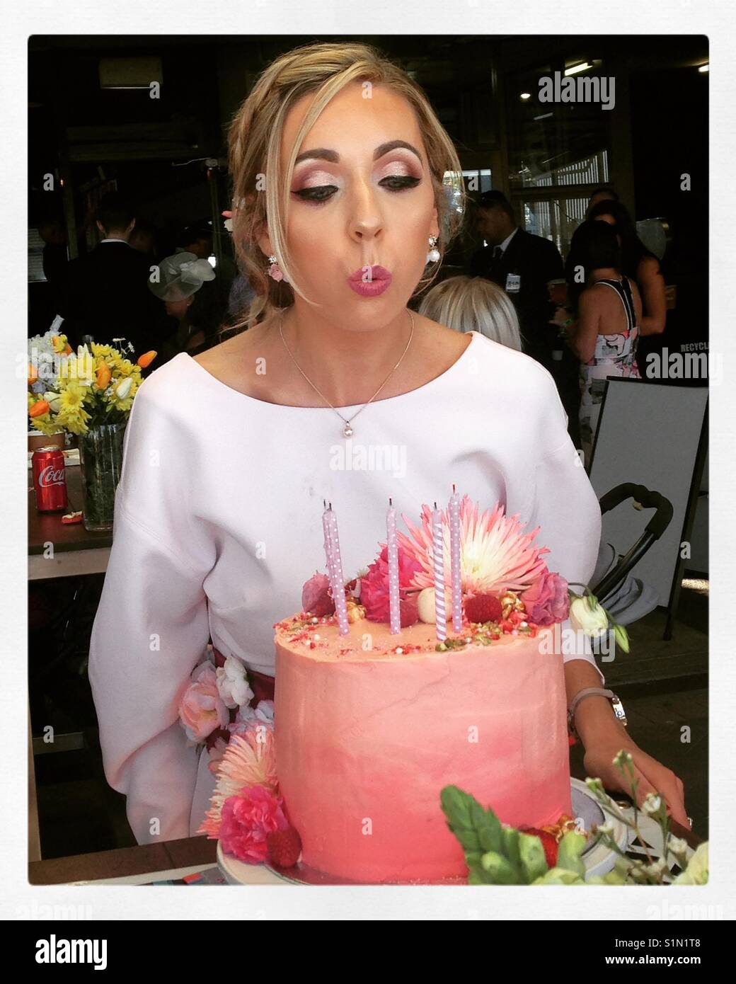 Birthday girl blowing out candles Stock Photo Alamy