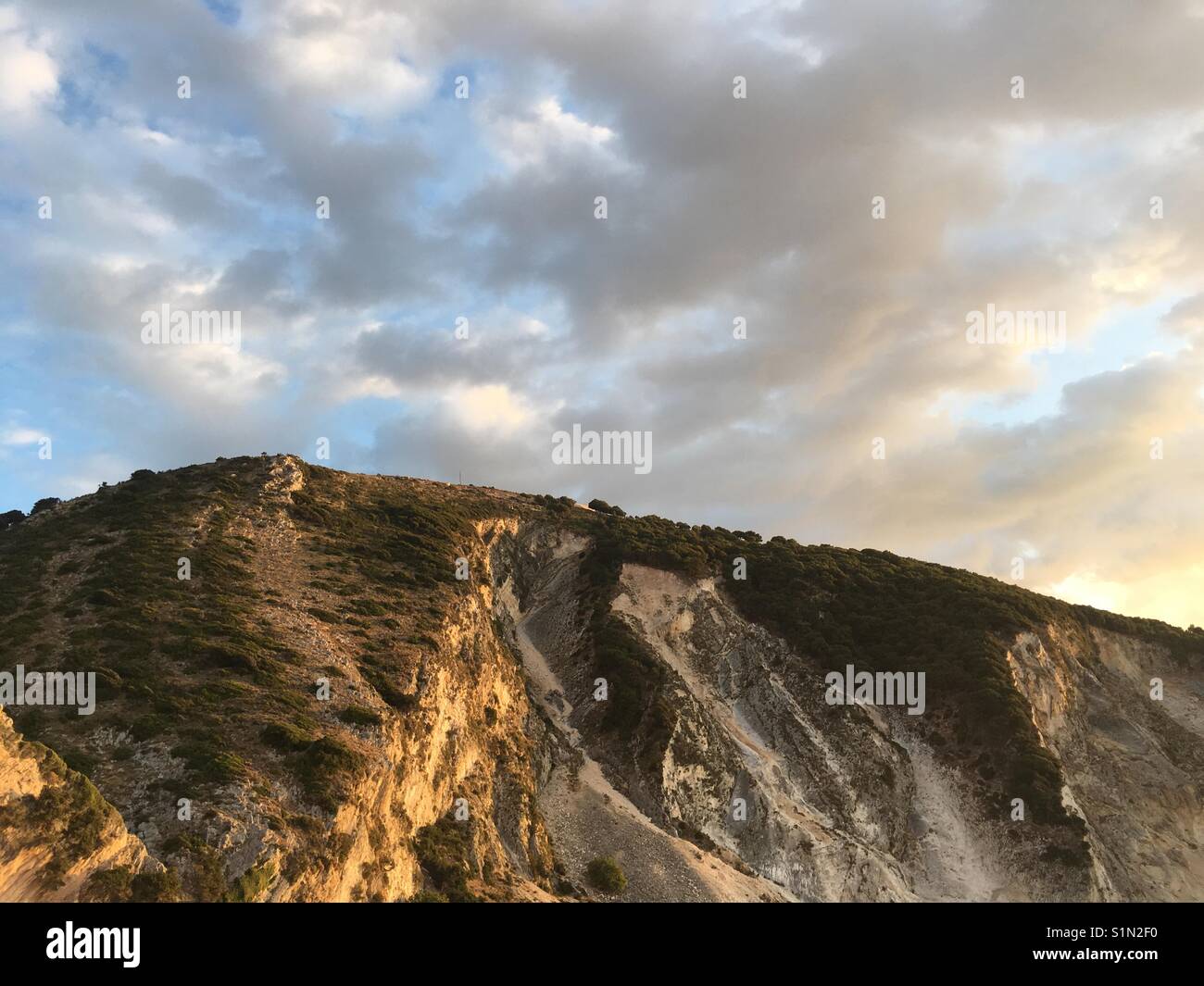 Golden hour on a mountain above Myrtos beach on Kefalonia island in Ionian Sea in Greece - Smartphone Captured Stock Image