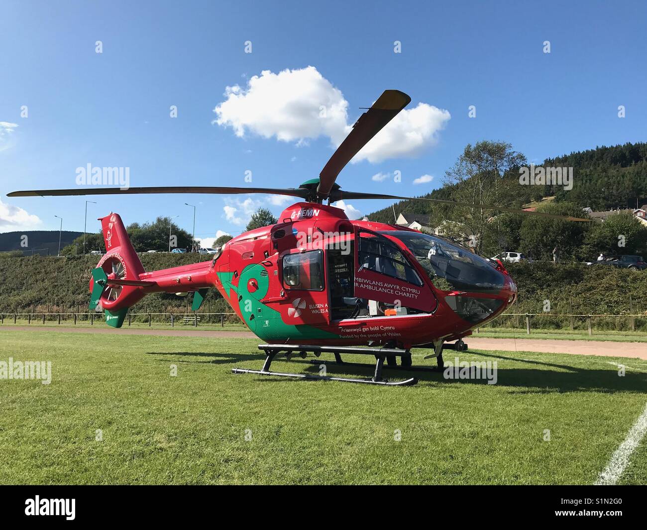 Wales Air Ambulance on a sports field while on an emergency call out - Smartphone Captured Stock Image