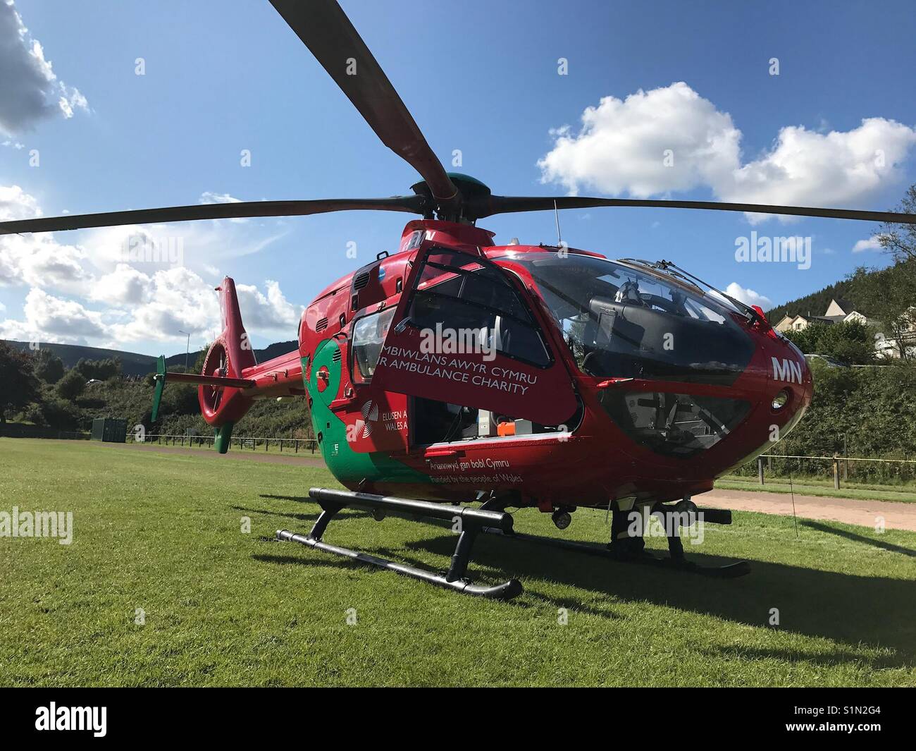 Wales Air Ambulance on a sports field while on an emergency call out - Smartphone Captured Stock Image