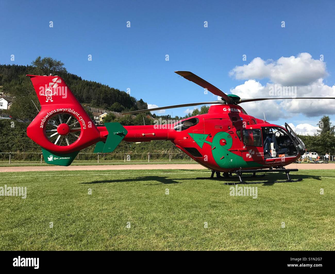 Wales Air Ambulance on a sports field while on an emergency call out - Smartphone Captured Stock Image