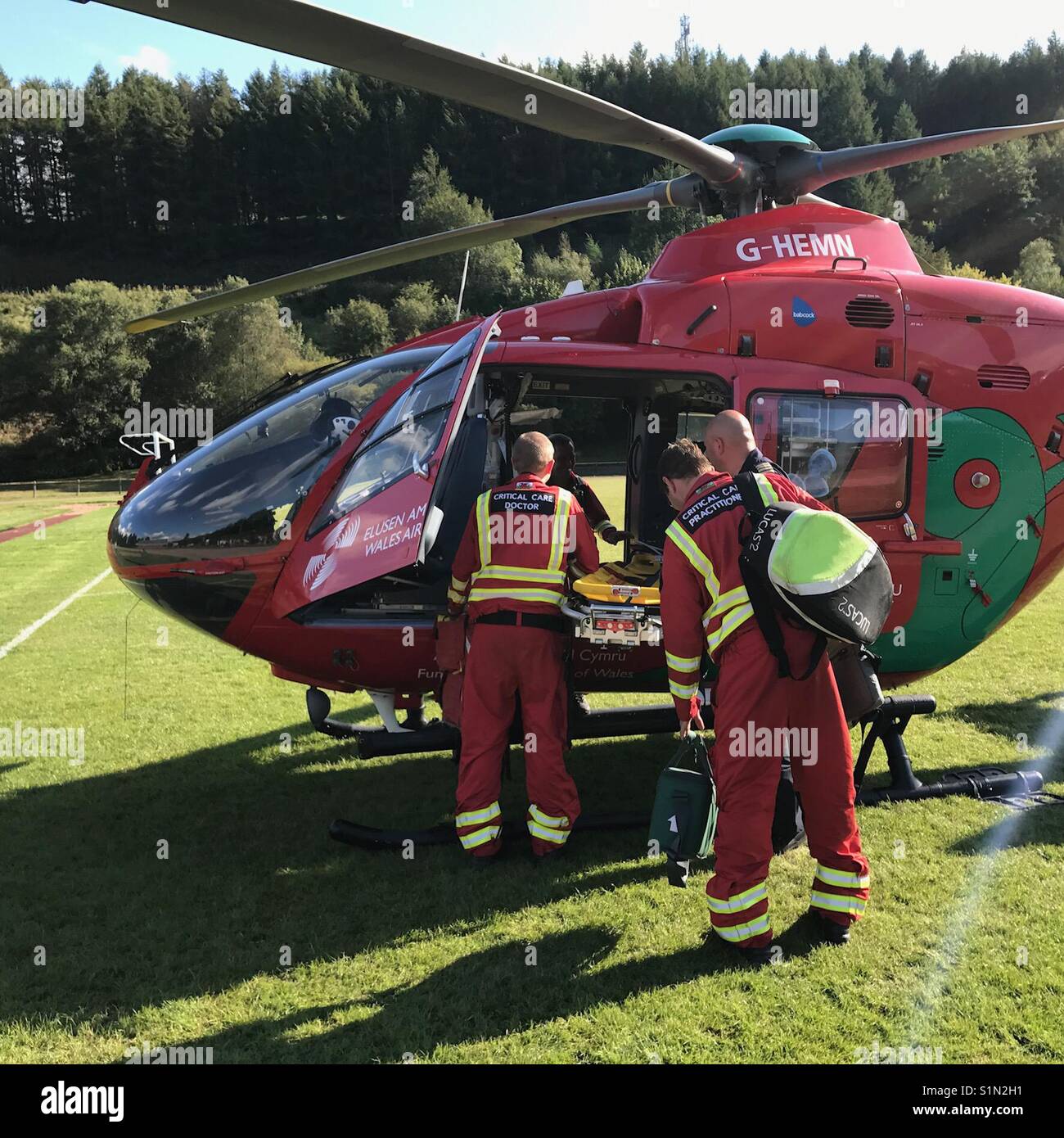 The crew in the process of boarding a Wales Air Ambulance - Smartphone Captured Stock Image