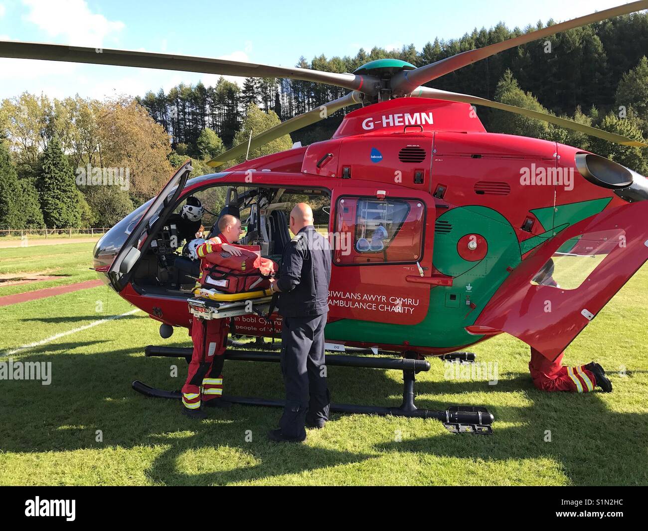 The crew load a Wales Air Ambulance with equipment whilst on an emergency call out - Smartphone Captured Stock Image