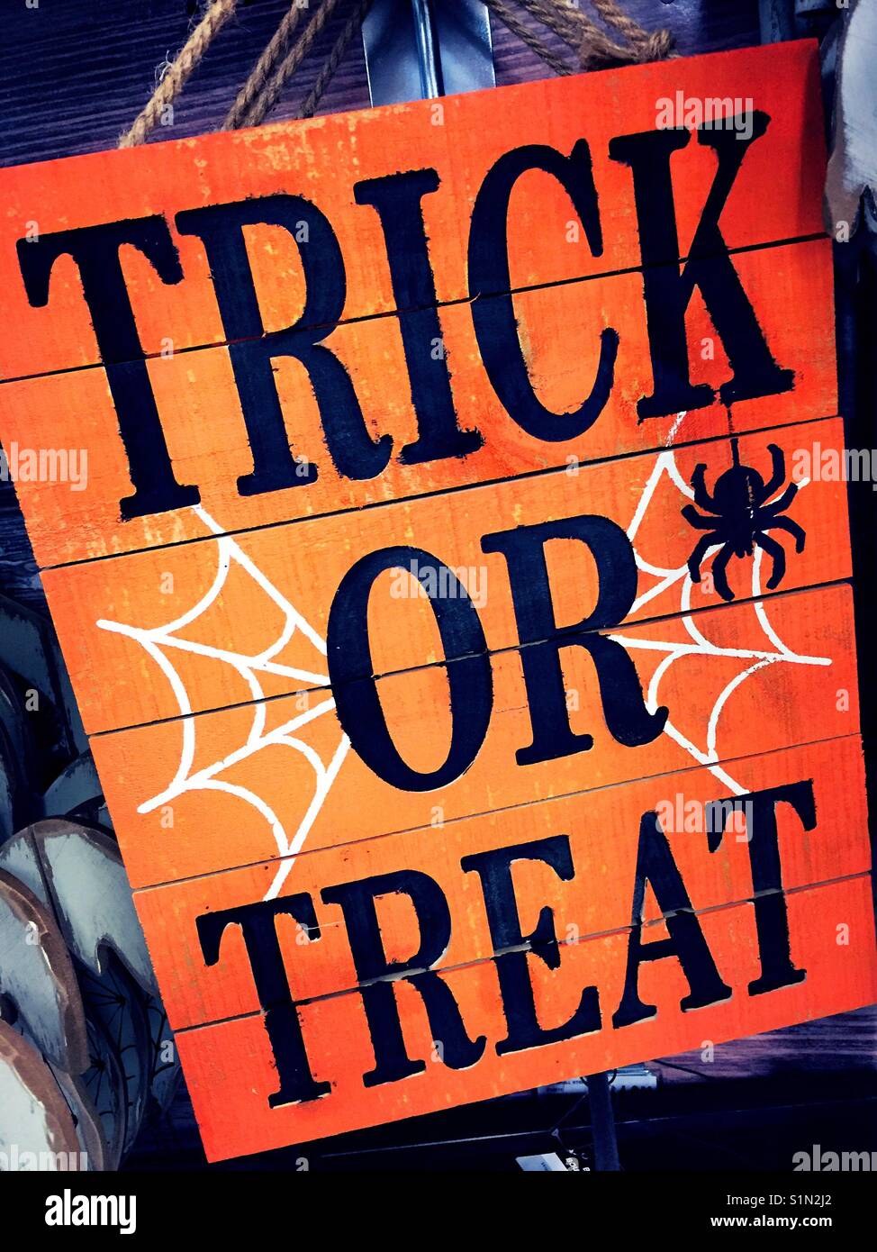 Trick or treat Halloween sign with cobwebs and spider, USA - Smartphone Captured Stock Image