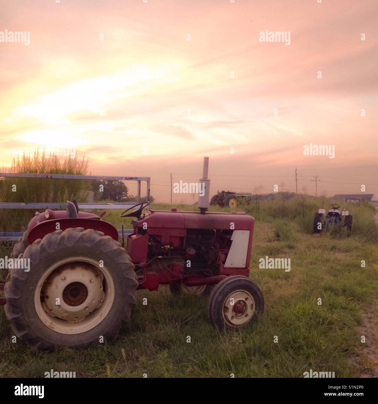 Three tractors parked in North Carolina sunset - Smartphone Captured Stock Image