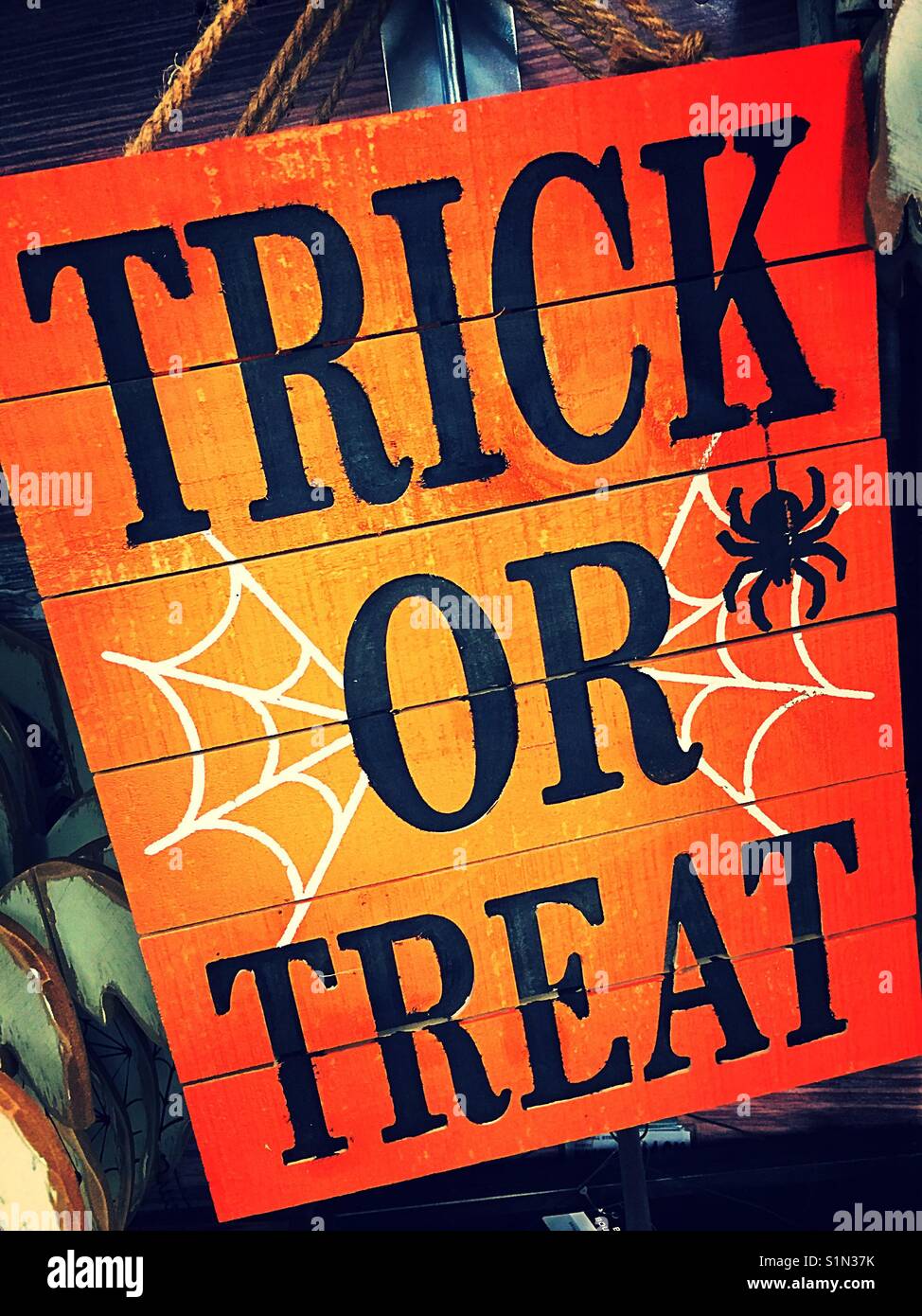Orange Halloween sign, trick or treat, cobwebs and spiders, USA - Smartphone Captured Stock Image