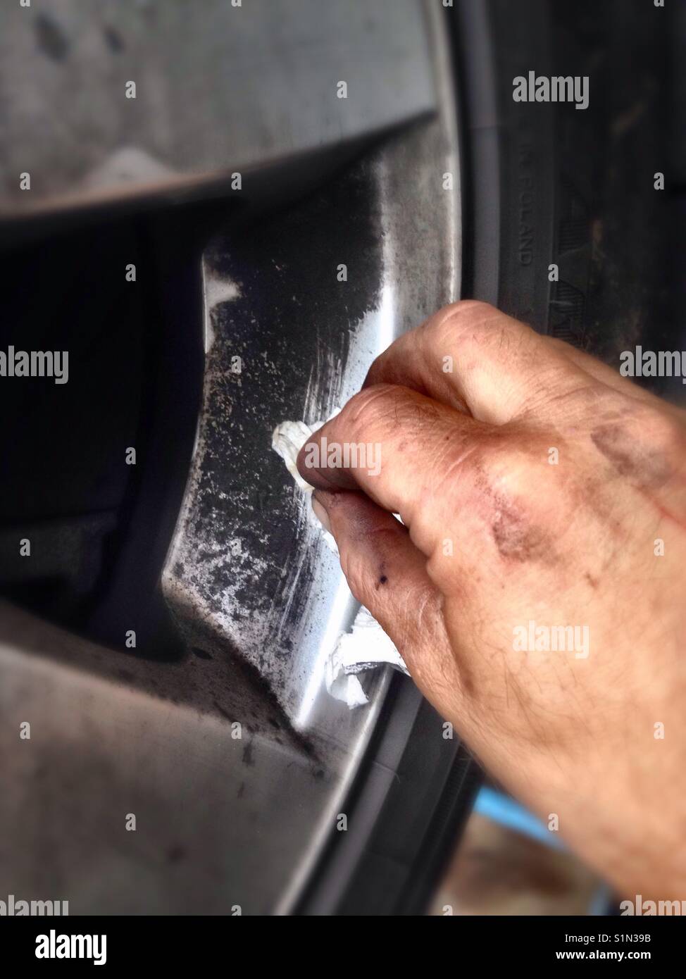 Removing dirt from car wheel Stock Photo Alamy