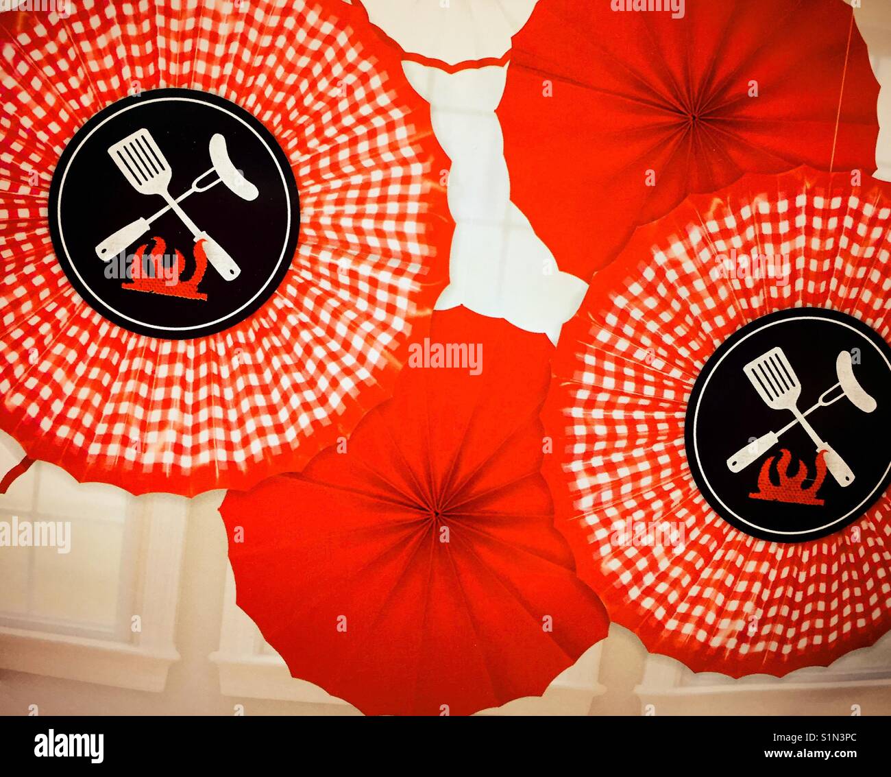 Umbrellas celebrating barbecue grill utensils, Labor Day, USA - Smartphone Captured Stock Image