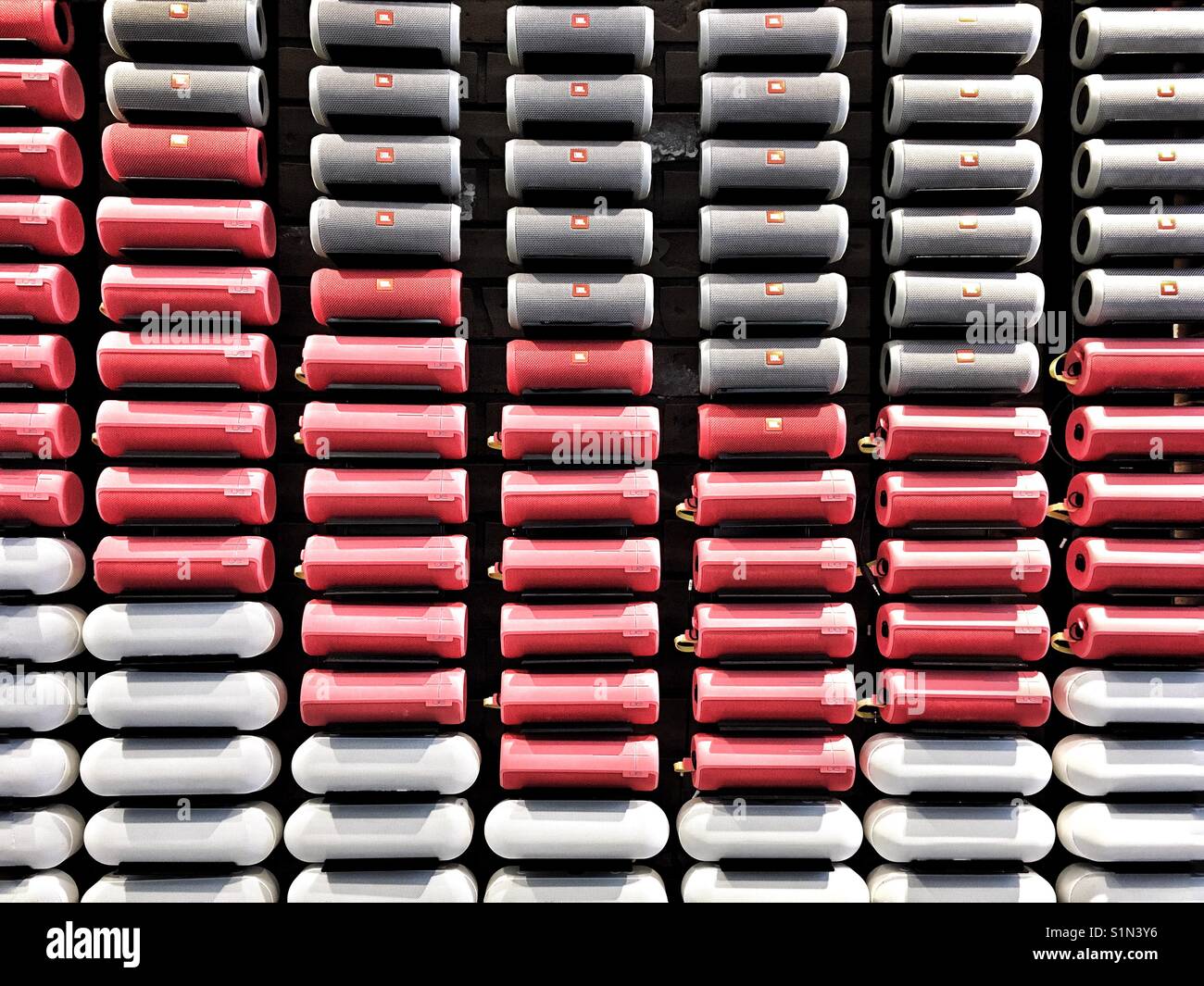 Wall of portable speakers in red, gray and white color. Pattern, abstract background - Smartphone Captured Stock Image