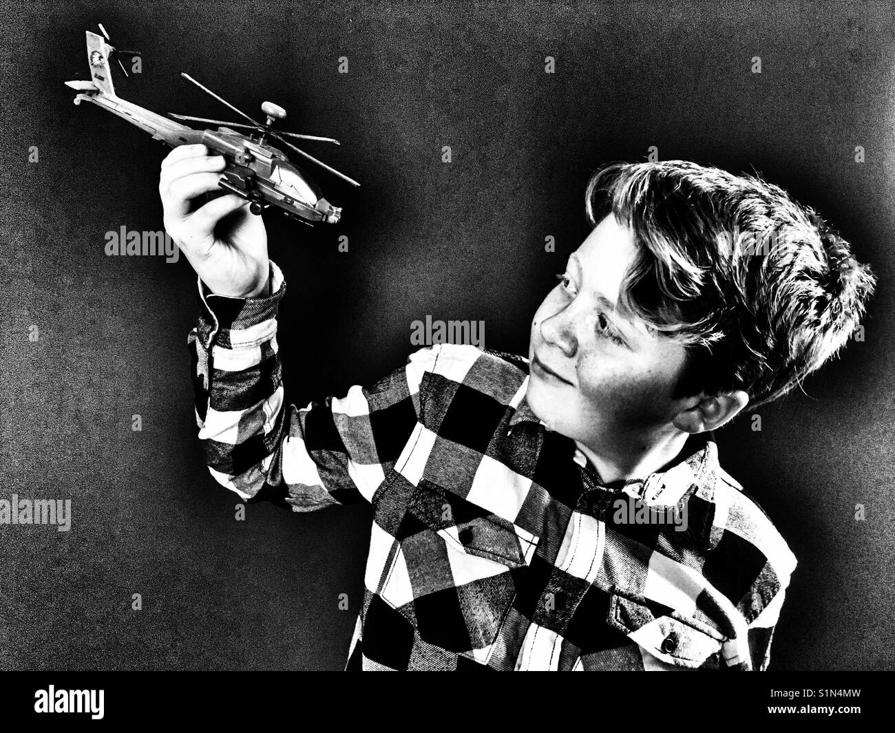 Boy playing with toy helicopter - Smartphone Captured Stock Image