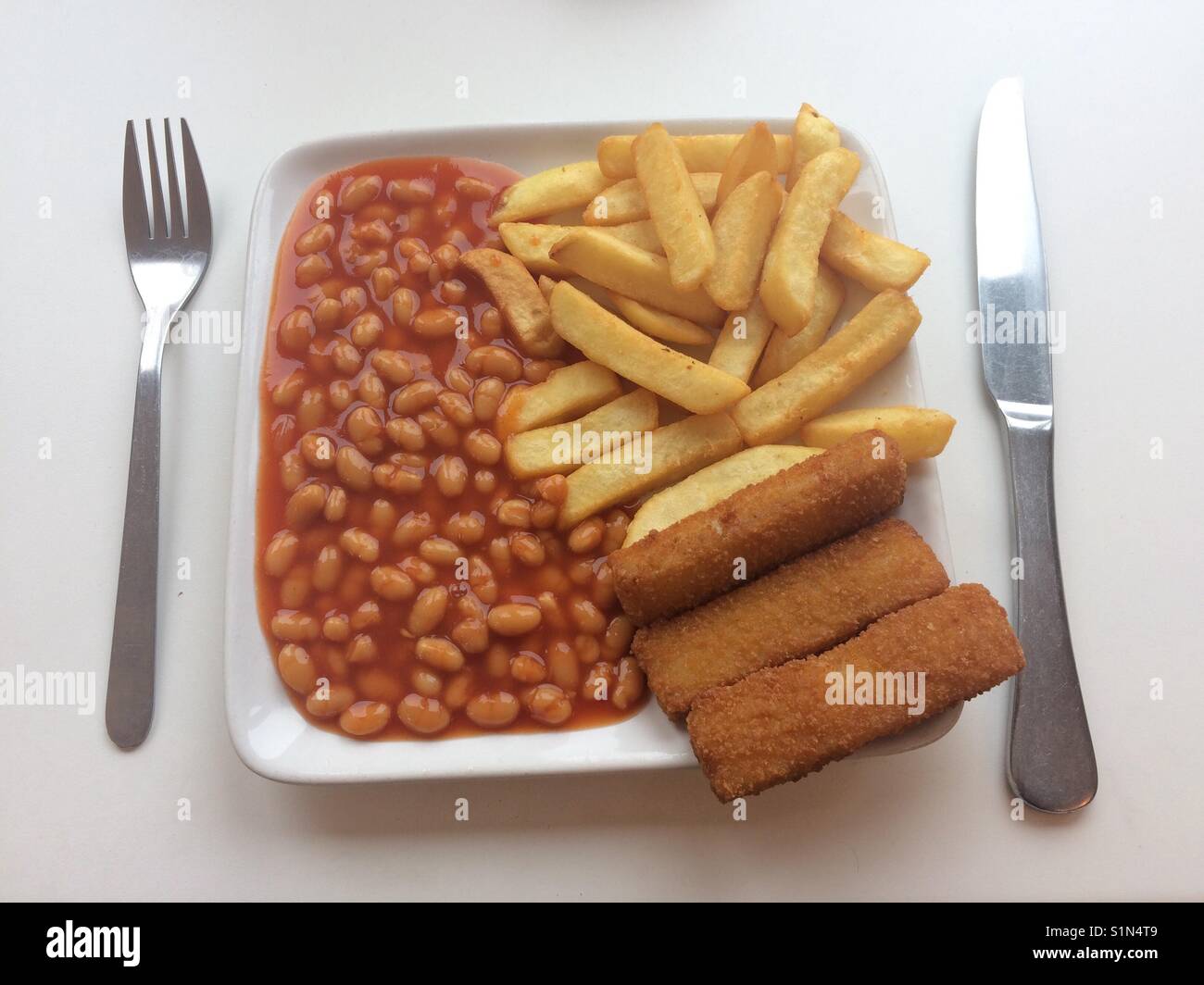 Fish fingers, chips and beans. Stock Photo