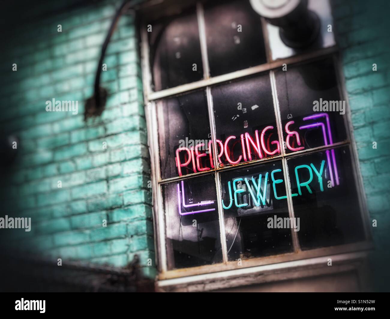 Body piercing establishment window Stock Photo